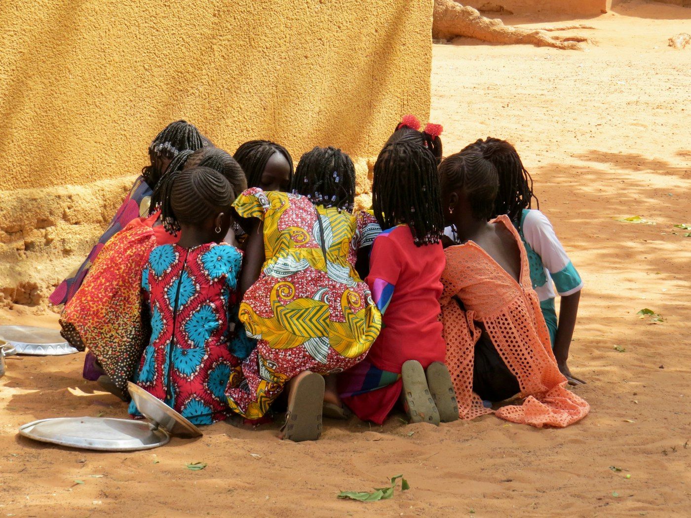 Children gathered together under a large tree with big branches